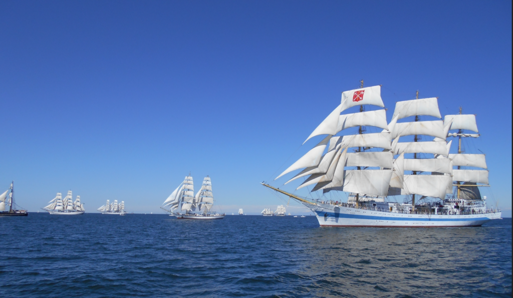 Numerous square riggers line the horizon with hundreds of eager RYA sailors aboard.