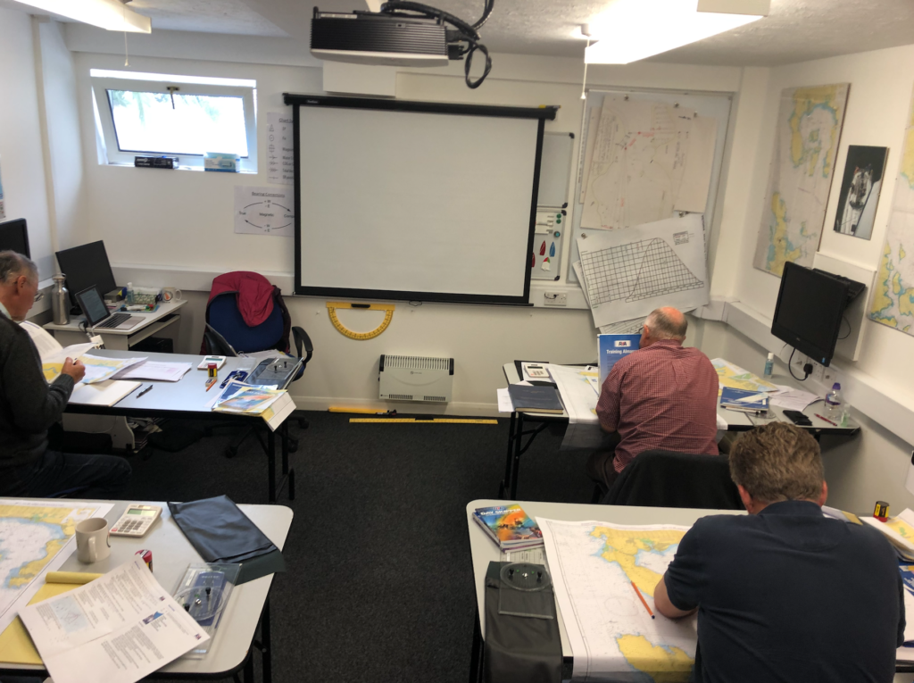 A shot from Ardent Trainings Chief Instructor Charly Hewett teaching an RYA Day Skipper Theory course in a classroom.