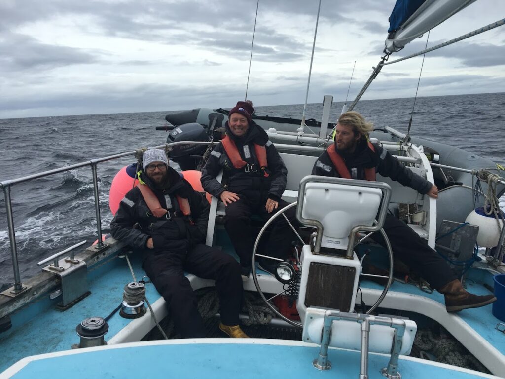 3 RYA Yachtmasters enjoying a windy day at sea.