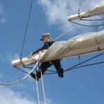 RYA Instructor Charly in the rigging on a tall ship