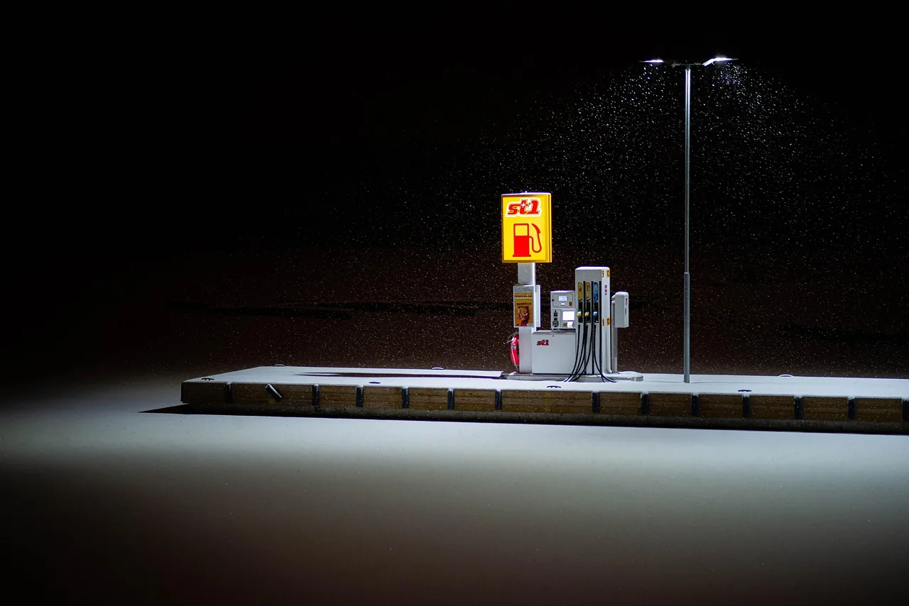 Illuminated fuel pump at a deserted filling station at night